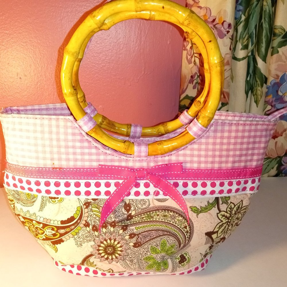PINK FLORAL PURSE WITH SQUARES CIRCLES AND STUDS AND BAMBOO HANDLES